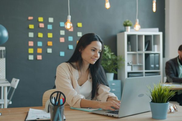 Woman working on laptop in modern office space